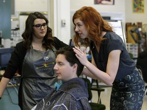 Archbishop O'Leary cosmetology teacher Desiree Caouette (right) instructs career program graduate Deena Halaby (left), who is styling Royce Boyer's hair.
