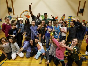 Edmonton Eskimos D'Anthony Batiste (left) and Grant Shaw pose for a group shot with students at Sweet Grass Elementary School in Edmonton, Alta., on Tuesday March 22, 2016 after a speech about bullying and the Internet. Photo by Ian Kucerak