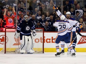 Edmonton Oilers' Leon Draisaitl (29) celebrates with teammate Patrick Maroon (19) after Maroon scored on Winnipeg Jets' goalie Ondrej Pavelec (31) during second period NHL hockey action, in Winnipeg on Sunday, Mar. 6, 2016.