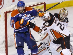 Edmonton's Patrick Maroon (19) and Anaheim's Shawn Horcoff (22) battle during the third period of an NHL game between the Edmonton Oilers and the Anaheim Ducks at Rexall Place in Edmonton on March 28, 2016.