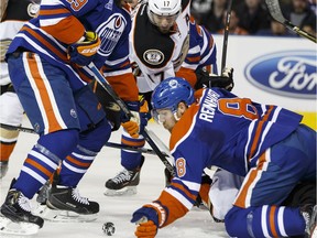 Edmonton's Griffin Reinhart (8) jumps on a loose puck in a dog pile with Anaheim players during an NHL game between the Edmonton Oilers and the Anaheim Ducks at Rexall Place in Edmonton, Alta., on Monday March 28, 2016.