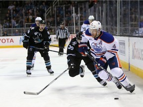 SAN JOSE, CA - MARCH 24:  Taylor Hall #4 of the Edmonton Oilers skates away from Logan Couture #39 of the San Jose Sharks at SAP Center on March 24, 2016 in San Jose, California.