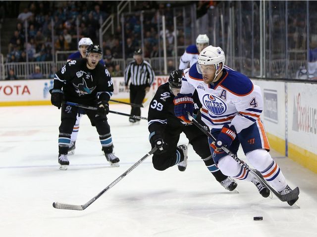 SAN JOSE, CA - MARCH 24: Taylor Hall #4 of the Edmonton Oilers skates away from Logan Couture #39 of the San Jose Sharks at SAP Center on March 24, 2016 in San Jose, California.