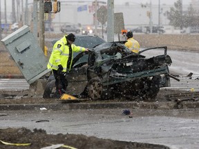 Police investigate at the scene of a serious car accident along northound Manning Drive near 50 Street, in Edmonton on Sunday March 13, 2016. ASIRT cleared a police officer who was pursuing the vehicle before the crash of any wrongdoing.