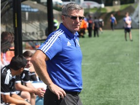 FC Edmonton head coach Colin Miller looks out onto the field at SMS Equipment Stadium before his club's match against Ottawa Fury FC in Fort McMurray Alta. on Sunday August 2, 2015. Robert Murray/Fort McMurray Today/Postmedia Network