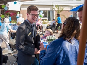 Jon Carson, Edmonton-Meadowlark MLA, visits with his constituents at Jasper Place Continuing Care Centre during a 50th anniversary celebration of the centre in Edmonton on August 27, 2015.