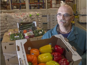Ed Giorgi, general manager of Sunfresh Farms, with some of the vegetables they distribute and grow. The peppers are from California, but the mini cucumbers are from Leduc and the rutabagas are from the Edson area.