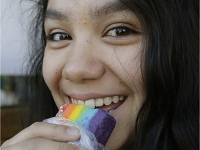 Arianna St.-Jacques eats some Pride flag-coloured fudge to celebrate the Jasper Pride Festival held March 18 to 20, 2016.