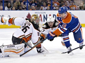 Anaheim Ducks goalie John Gibson (36) makes the save on Edmonton Oilers' Nail Yakupov (10) as Hampus Lindholm (47) defends during first period NHL action in Edmonton, Alta., on Monday March 28, 2016.