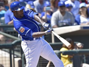 Kansas City Royals' Lorenzo Cain connects on a single in the first inning during a spring training baseball game against the Oakland Athletics, Saturday, March 26, 2016 in Surprise, Ariz. (John Sleezer/The Kansas City Star via AP) MANDATORY CREDIT ORG XMIT: MOKAS302