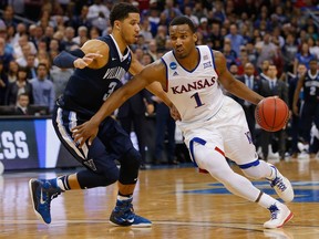 Wayne Selden Jr. #1 of the Kansas Jayhawks drives against Josh Hart #3 of the Villanova Wildcats in the second half during the 2016 NCAA Men's Basketball Tournament South Regional at KFC YUM! Center on March 26, 2016 in Louisville, Kentucky.