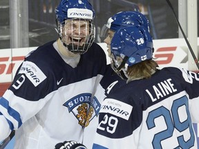 From left, Finland's Jesse Puljujarvi, Sebastian Aho and Patrik Laine celebrate a goal by Puljujarvi during the 2016 IIHF World Junior Ice Hockey Championship game vs. Belarus in Helsinki, Finland, on Dec. 26, 2015.