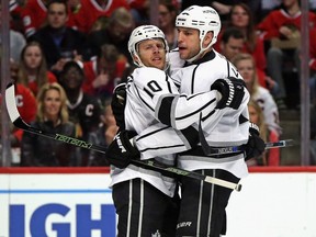 Kris Versteeg of the Los Angeles Kings, left, gets a hug from Milan Lucic after scoring a first period goal against the Chicago Blackhawks at the United Center on March 14, 2016 in Chicago, Illinois.