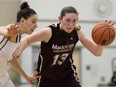 MacEwan Griffins' Kelly Fagan (13) battles Jenna Bugiardini of the Victoria Vikes during Canada West women's basketball action at MacEwan University in Edmonton on March 5, 2016. MacEwan won 77-62.