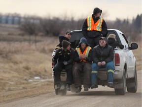 Volunteers leave the Martens' residence as RCMP Sgt. Bert Paquet speaks to media on the discovery of two-year-old Chase Martens' body in a creek close to his home just north of Austin, Manitoba on Saturday, March 26, 2016. Martens went missing from his family home Tuesday evening.