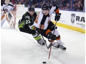 The Edmonton Oil Kings' Colton Kehler (23) battles the Medicine Hat Tigers' Ty Schultz (15) during third period WHL action at Rexall Place, in Edmonton Alta. on Friday March 4, 2016.The Tigers won 5-4. Photo by David Bloom