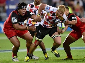 Jacques Engelbrecht (R) of the Southern Kings is tackled by Michael Alaalatoa of the Canterbury Crusaders during the Super Rugby match between New Zealand's Canterbury Crusaders and South Africa's Southern Kings at AMI Stadium in Christchurch on March 19, 2016.