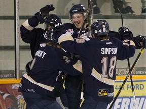 Spruce Grove Saints players celebrate a first period goal against the Sherwood Park Crusaders at the Sherwood Park Arena during game 3 of the their best-of-seven AJHL North Division semifinal on March 21, 2016 .