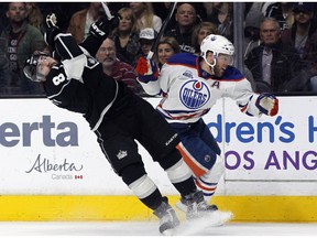 Edmonton Oilers left winger Taylor Hall knocks back Los Angeles Kings defenceman Drew Doughty in pursuit of the puck Saturday in L.A.