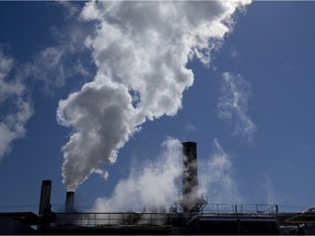 The sun shines through steam as it rises high above the roofline of the London District Energy building.