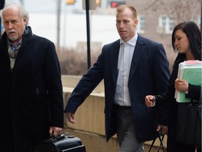 Travis Vader, centre, arrives at court with lawyer Brian Beresh, left, in Edmonton on Tuesday, March 8, 2016. Vader is charged with first-degree murder in the 2010 deaths of Lyle and Marie McCann.