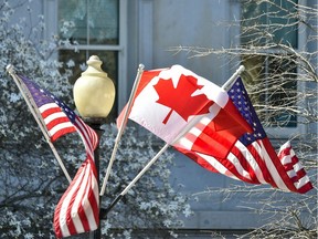 U.S. and Canadian flags hang from a lamp post on the grounds of the White House in Washington, DC, on March 9, 2016 on the eve of the state visit of Canadian Prime Minister Justin Trudeau.