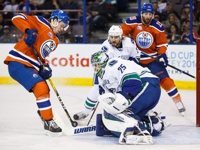 Connor McDavid #97 of the Edmonton Oilers tries to put a shot past goaltender Jacob Markstrom #25 of the Vancouver Canucks on March 18, 2016 at Rexall Place in Edmonton, Alberta, Canada.