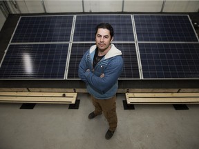 Dave Pearson, a journeyman electrician who has started his own solar installation copmany, poses for a photo in front of a solar array at Iron + Earth's office, in Edmonton on March 21, 2016.  Avi Lewis, Tony Alexis and Joel French write that the Iron + Earth initiative is the kind of effort Alberta's carbon tax should support.