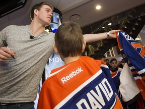 The Edmonton Oilers' Connor McDavid hands out autographed jerseys to minor jockey players from the KC Renegades, during a surprise visit with the team at the West Edmonton Mall Sport Chek, in Edmonton Alta. on Monday April 11, 2016.