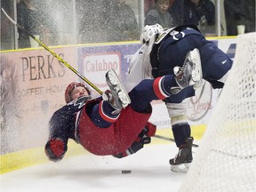 The Spruce Grove Saints' Trey Fix-Wolansky (20) checks the Brooks Bandits' CaleMakar (8) during first period AJHL action at Grant Fuhr Arena, in Spruce Grove Alta. on Friday April 15, 2016.