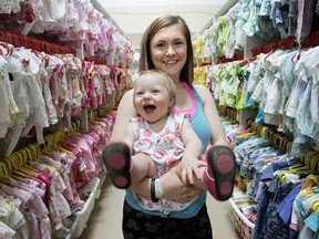 Basically Babies' client Victoria Jordahl, 17, and her daughter Mary Larson, 1, pose for a photo at the Basically Babies warehouse.