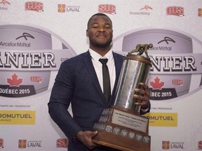 David Onyemata, of the University of Manitoba, holds the J.P. Metras Trophy as the most outstanding down lineman of the year during CIS Awards gala, November 26, 2015 in Quebec City. Manitoba Bisons defensive lineman David Onyemata was selected by the New Orleans Saints in the fourth round, 120th overall, of the NFL draft Saturday. THE CANADIAN PRESS/Jacques Boissinot