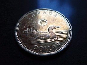 A Canadian dollar or loonie is pictured in North Vancouver, on March 5, 2014.