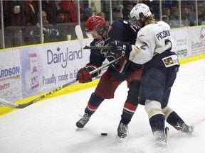 The Spruce Grove Saints' Macklin Pichonsky (2) battles the Brooks Bandits' Josh McKechney (13) during second period AJHL action at Grant Fuhr Arena, in Spruce Grove Alta. on Saturday April 16, 2016. This was game 2 of the 2016 Alberta Junior Hockey League Gas Drive Cup. Photo by David Bloom