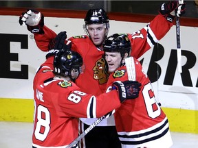 Chicago Blackhawks right wing Andrew Shaw, right, celebrates with right wing Patrick Kane, left, and center Jonathan Toews after scoring a goal against the St. Louis Blues during the third period in Game 6 of an NHL hockey first-round Stanley Cup playoff series on April 23, 2016, in Chicago.