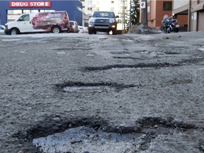 Potholes in an alley south of Jasper Avenue and 119 Street in February 2016.