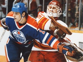 The Battle of Alberta:  Edmonton Oilers forward Esa Tikkanen battles Flames goalie Mike Vernon during NHL playoff action at the Calgary Saddledome in April 1986.