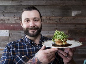 Chartier restaurant owner Darren Cheverie holds a pork jowl cake.