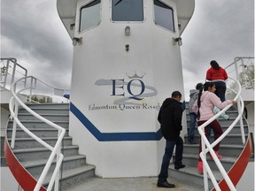 A family walks up to the bridge of the Edmonton Queen during an open house Saturday for the sale of the riverboat.