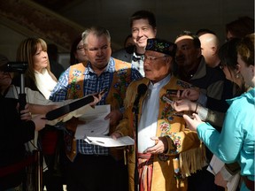 Metis National Council president Clement Chartier speaks to reporters as he is flanked by fellow Metis leaders following a decision at the Supreme Court of Canada in Ottawa on April 14, 2016. The ruling made it clear that the federal government must fulfill its responsibilities toward all indigenous peoples, including the Metis.