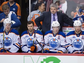 Edmonton Oilers head coach Todd McLellan, back, stands on the bench behind Edmonton Oilers' Connor McDavid, from left, Jordan Eberle, Ryan Nugent-Hopkins and Taylor Hall during the second period of an NHL hockey game against the Vancouver Canucks in Vancouver, B.C., on Saturday April 9, 2016.