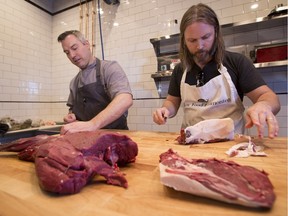 Chef Blair Lebsack (left) prepares meat in The Butchery portion of RGE RD.