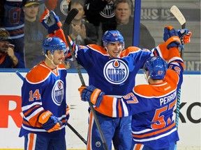 EDMONTON, AB. NOVEMBER 19, 2013-  From left, Jordan Eberle (14), Nail Yakupov (64) and David Perron (57) of the Edmonton Oilers, celebrate Yakupov's goal in the second period against  the Columbus Blue Jackets at Rexall Place in Edmonton. Shaughn Butts/Edmonton Journal