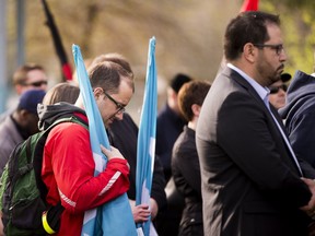 People take part in a Day of Mourning ceremony hosted by the Edmonton and District Labour Council (EDLC) to recognize those workers killed and injured at work and to recommit to working toward ending workplace deaths and injuries, on April 28, 2016, in Edmonton.  The event was held at the Broken Families Obelisk at Grant Notley Park.