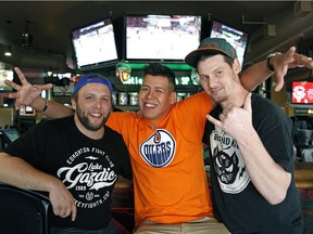 Hockey fans (left to right) Grant Johnson, Ammon Bodie and Bruce Irons discuss the NHL Draft Lottery at the Canadian Brewhouse in Edmonton.