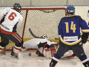 A letter writer urges Hockey Edmonton to delay its new ban on checking in lower levels of bantam and midget play by a year so it can consult with parents, players and coaches. This 2012 file photos comes from a game during a midget tournament between the CAC Butchers and the Leduc Windsor Plywood Roughnecks.