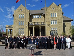 Rachel Notley and newly elected NDP MLAs line up in front of Government House before their first Caucus meeting on May 9, 2015.