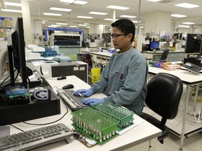 Medical laboratory technologist Janette Peralta at work in the DynaLIFE central lab facility in Edmonton.