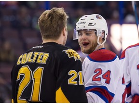 Edmonton's Aaron Irving (24) and Brandon's Tyler Coulter (21) swap words during playoff action at Rexall Place in Edmonton, Alta on Thursday, March 31, 2016.