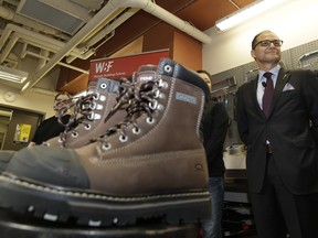 Alberta Minister of Finance Joe Ceci displayed his 2016 budget boots in Edmonton on April 13, 2016, one day before his government released a budget it dubbed the Alberta Jobs Plan.